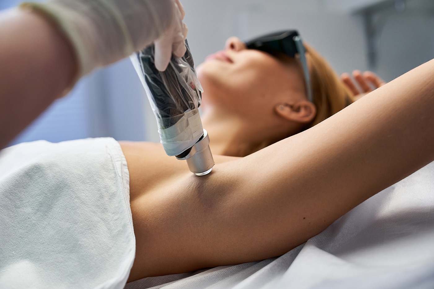 Female patient receiving IPL treatment on her left armpit at Elysian Medspa & Rejuvenation Center in Indianapolis, Indiana